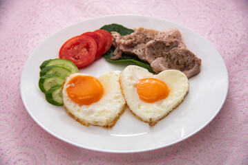 fried eggs with bacon and vegetables