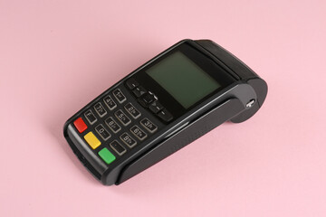 New modern payment terminal on pink background