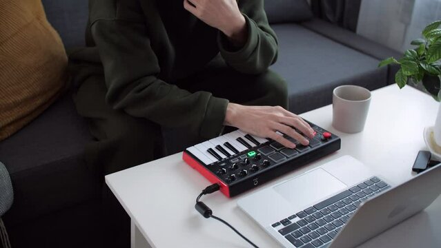 Hobby and creativity concept. Musician is recording tunes on his computer music
