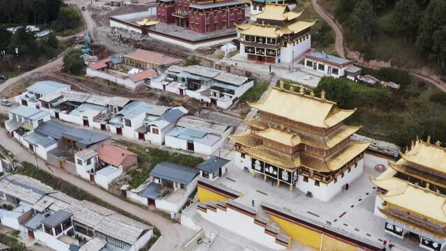 Beautiful Gelugpa sect monastery in Amdo Tibetan region with gold roofs and monks' houses