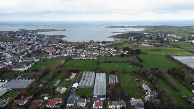 Flight from Braye Road over L&rsquo;Islet to Grand Havre and Picquerel Point Vale Guernsey on bright but cloudy day with calm sea