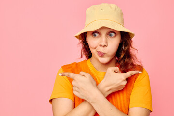 beautiful woman in an orange sweater in yellow hat hand gesture isolated backgrounds unaltered