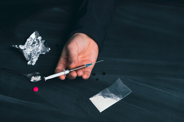 Addict man with syringe using drugs.