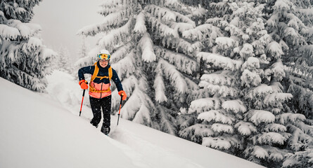 Mountaineer backcountry ski walking ski woman alpinist in the mountains. Ski touring in alpine...