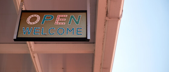 Vintage welcome light signs decorated in the front of the shop in 90's style.