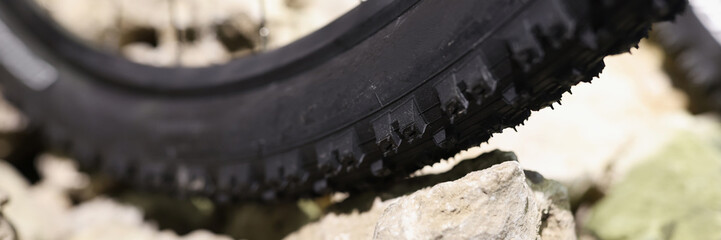 Bicycle rubber wheel standing on stones closeup