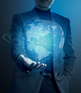 Businessman holding a modern virtual digital globe in his hand in concept of great potentail of handling things or business information.