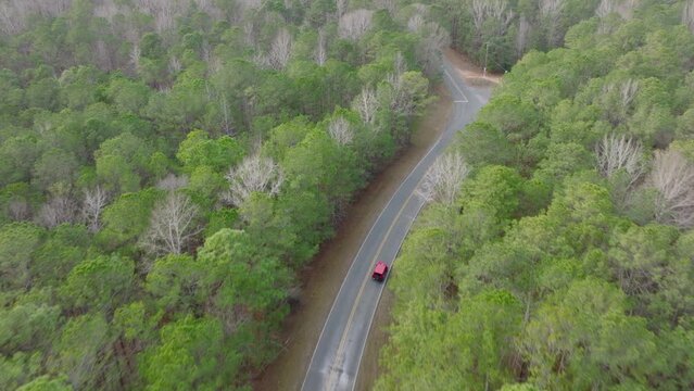 Aerial Tilt of a Jeep Wrangler on a Rural Winding Road