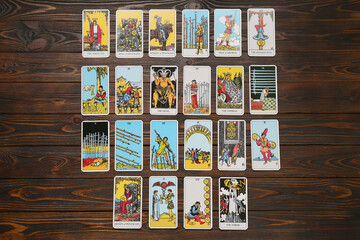 Tarot cards on wooden table, flat lay