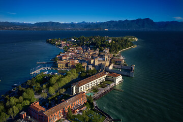 Fototapeta na wymiar Sirmione aerial view. Top view of the historic center of the Sirmione peninsula, lake garda. Lake Garda, Sirmione, Italy. Italian castle on Lake Garda. Aerial panorama of Sirmione.