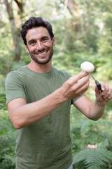 Naklejka na ściany i meble man found a mushroom in the forest