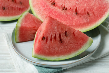 Slices of tasty ripe watermelon on white wooden table, closeup