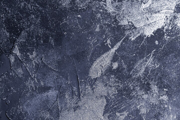 abstract creative background: rough cement plaster with spots of different tones, light color toning, short focus.