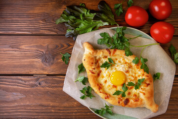 Traditional Georgian pastry khachapuri. Open pie with mozzarella and egg.