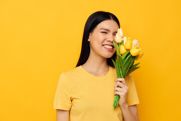 Portrait Asian beautiful young woman with a bouquet of yellow flowers romance isolated background unaltered