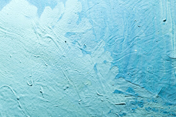 abstract creative background: oil paint frozen in a container after dilution, light color toning, short focus.