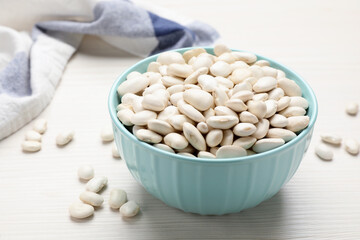 Raw beans on white wooden table, closeup