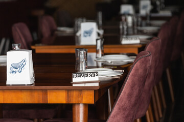 Close-up of a sign reserved on a wooden stand in a restaurant, cafe