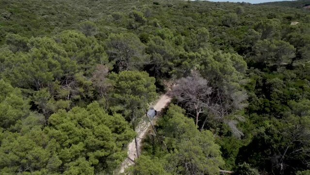 Industrial van approaching a water reservoir in the mountains near Gignac France, Aerial follow over shot
