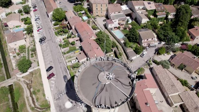 Water tank equipped as cell tower in Gignac France, Aerial tilt down shot