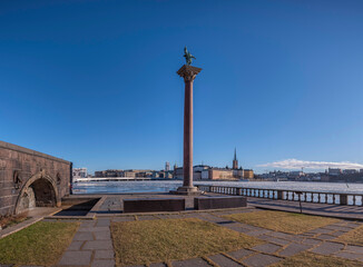 Obraz premium Panorama view, from the Town City Hall parterre with statue on a column capital and skyline of the government houses and the court houses on the island Riddarholmen, Stockholm