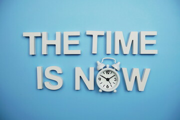 The Time is Now alphabet letters on blue background