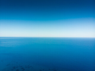 Seascape against blue clear sky