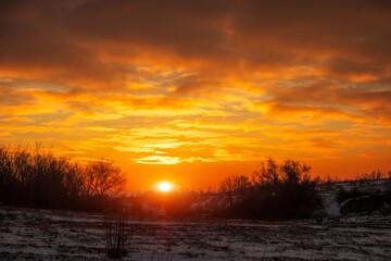 Fiery bright orange sunrise on a cold winter day. Early morning before hunting.