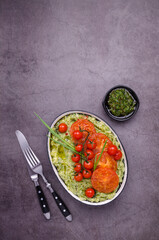 Spicy green mashed potatoes with fried tomatoes