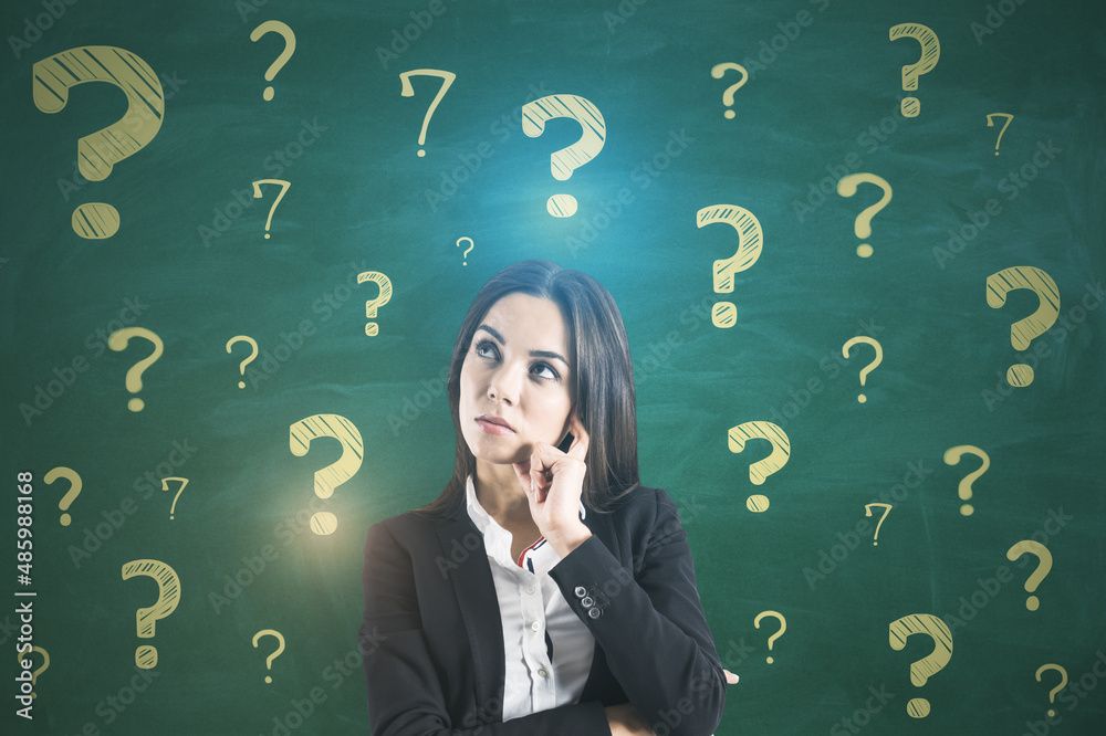 Poster portrait of attractive thoughtful young european businesswoman on chalkboard wall background with qu