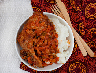 Traditional south African pap and roasted chicken, maize meal with chicken piece and chakalaka sauce