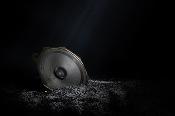 dusty speaker on black background