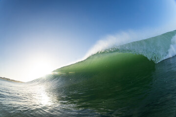 perfect breaking wave with blue skies