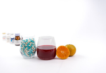 glass of orange juice and oranges