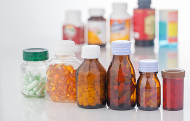 medicine bottle and pills on white background