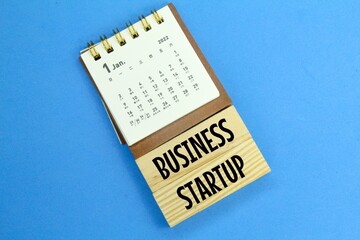 calendars and wooden boards with the words Business Startup