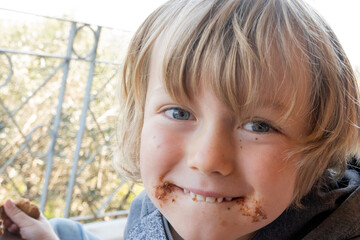 Close up of boy eating chocolate cookie