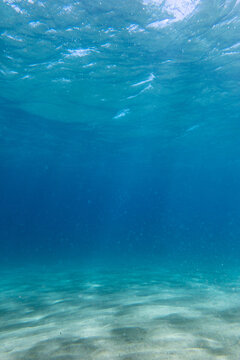 Underwater sea with reflection of sunlight on sand