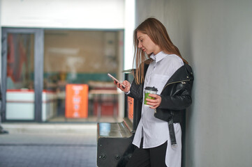 Girl with phone and coffee