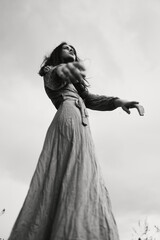 beautiful woman in dress gesturing with hands posing black and white photo