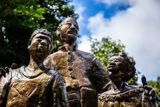 Mahe, Seychelles, 3.05.2021. The Liberated Slave Monument depicting three sculpted statues of two Liberated Slave children and a Headmaster, in Venn's Town Mission Lodge, Seychelles, close-up view.