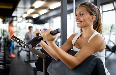 Fototapeta na wymiar Portrait of happy fit women working out is gym to stay healthy. Sport people concept