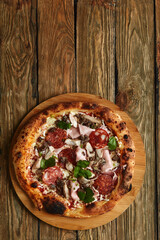 Meat Italian pizza with roast beef, steak slices, melted cheese, with olive slices and cheddar cheese. Close up, macro. Pizza time concept.