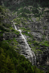 Scenic view of waterfall on rugged rock face