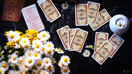 Fototapeta na wymiar Woman forecasting with Tarot cards, Fortune telling esoteric tarot predictions