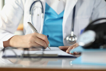 Doctor fill patient illness history or prescribe medication for client, busy doctor