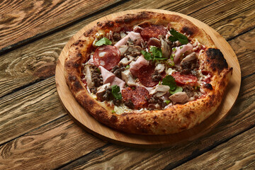 Meat Italian pizza with roast beef, steak slices, melted cheese, with olive slices and cheddar cheese. Close up, macro. Pizza time concept.