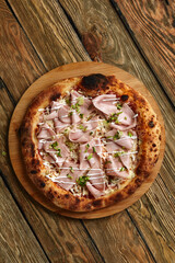 Meat Italian pizza with roast beef, steak slices, melted cheese, with olive slices and cheddar cheese. Close up, macro. Pizza time concept.