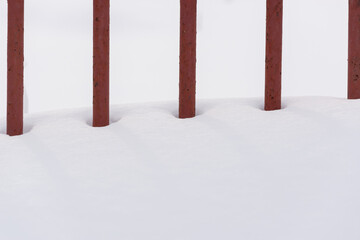 Fence from metal rods in the snow.