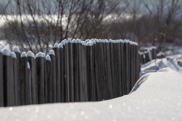 Wooden fence old and snow.